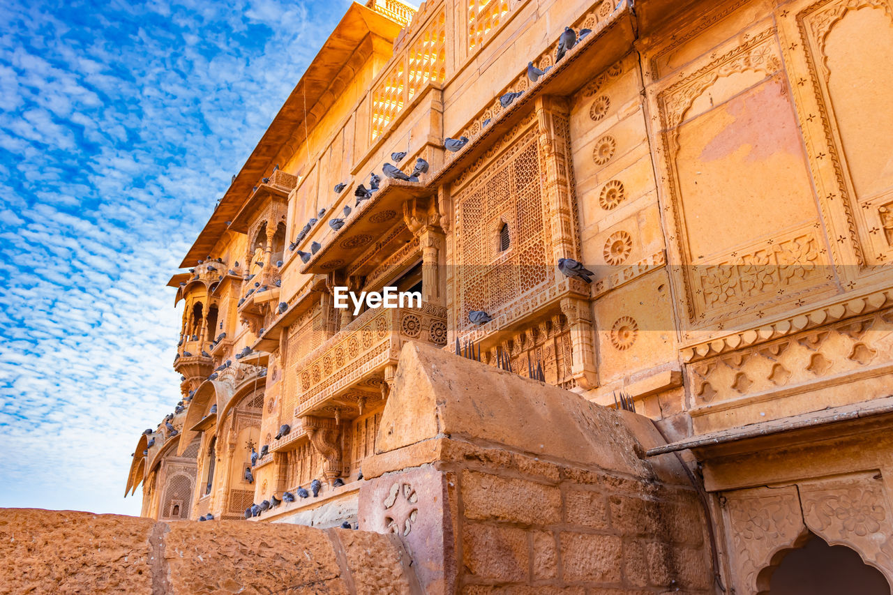 architecture, history, the past, built structure, travel destinations, ancient, building exterior, travel, temple, ancient history, sky, nature, tourism, craft, low angle view, no people, religion, landmark, building, temple - building, wall, ancient civilization, outdoors, blue, stone material, day, city, old, historic site, monument, belief, old ruin, memorial, facade, place of worship, cloud
