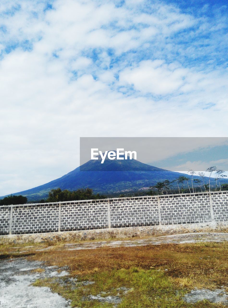 BUILT STRUCTURE ON MOUNTAIN AGAINST SKY