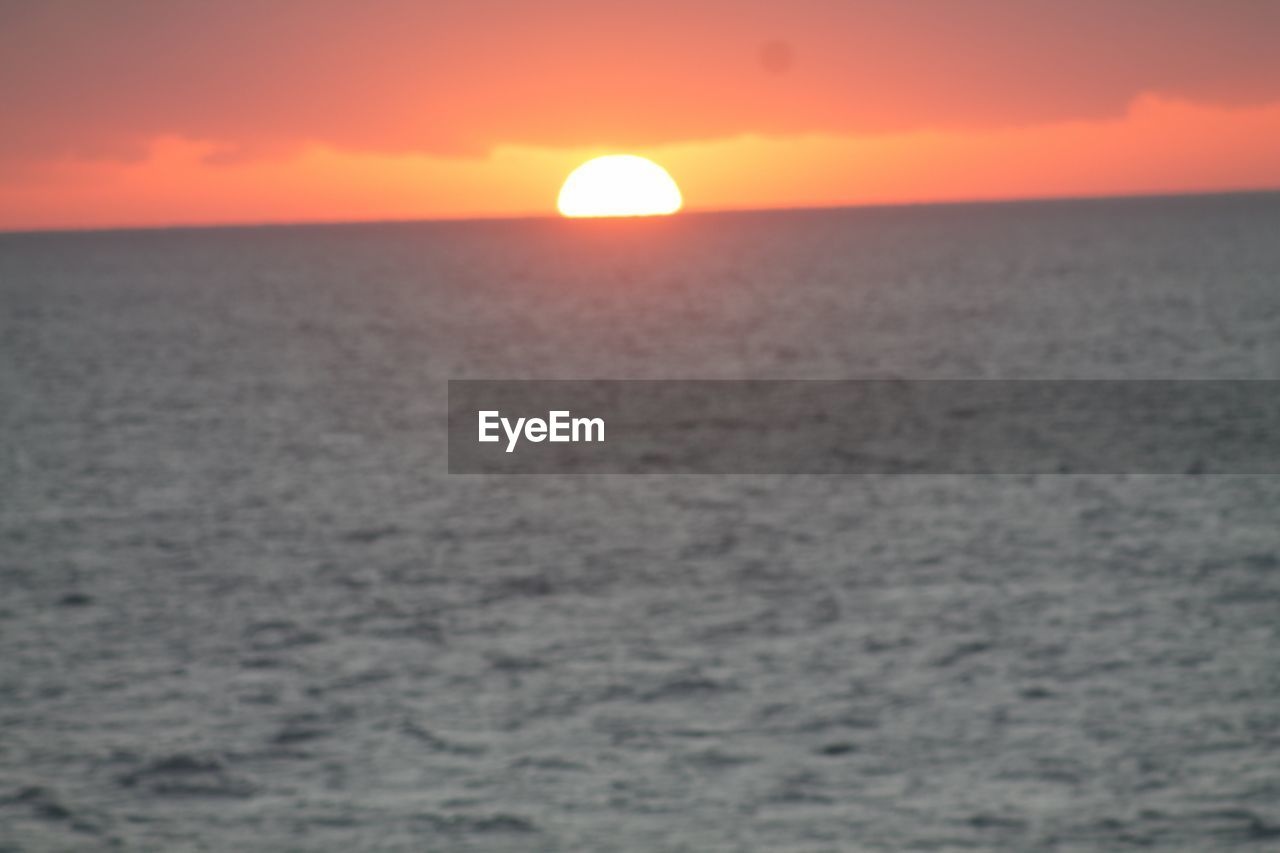 SCENIC VIEW OF SEA AGAINST ORANGE SKY