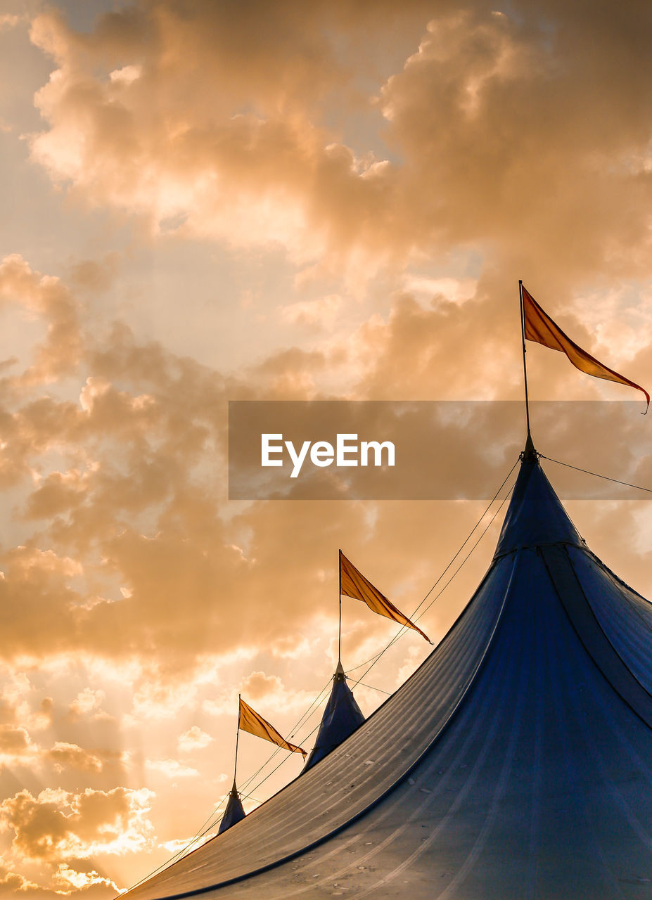 Low angle view of festival tent against sky during sunset