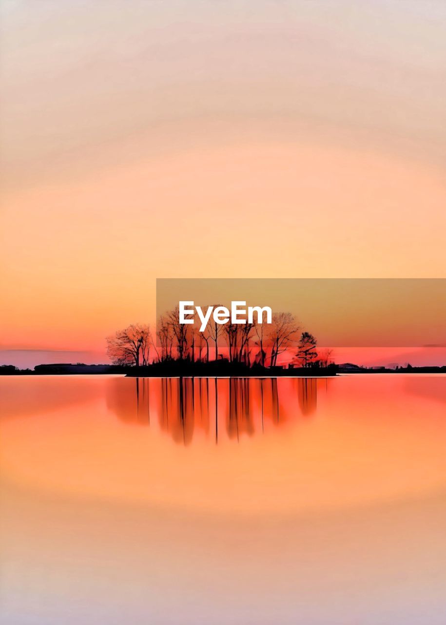 scenic view of lake against orange sky during sunset