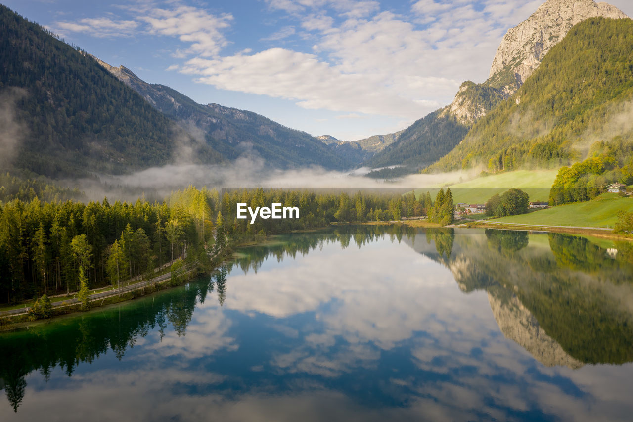 Scenic view of lake and mountains against sky