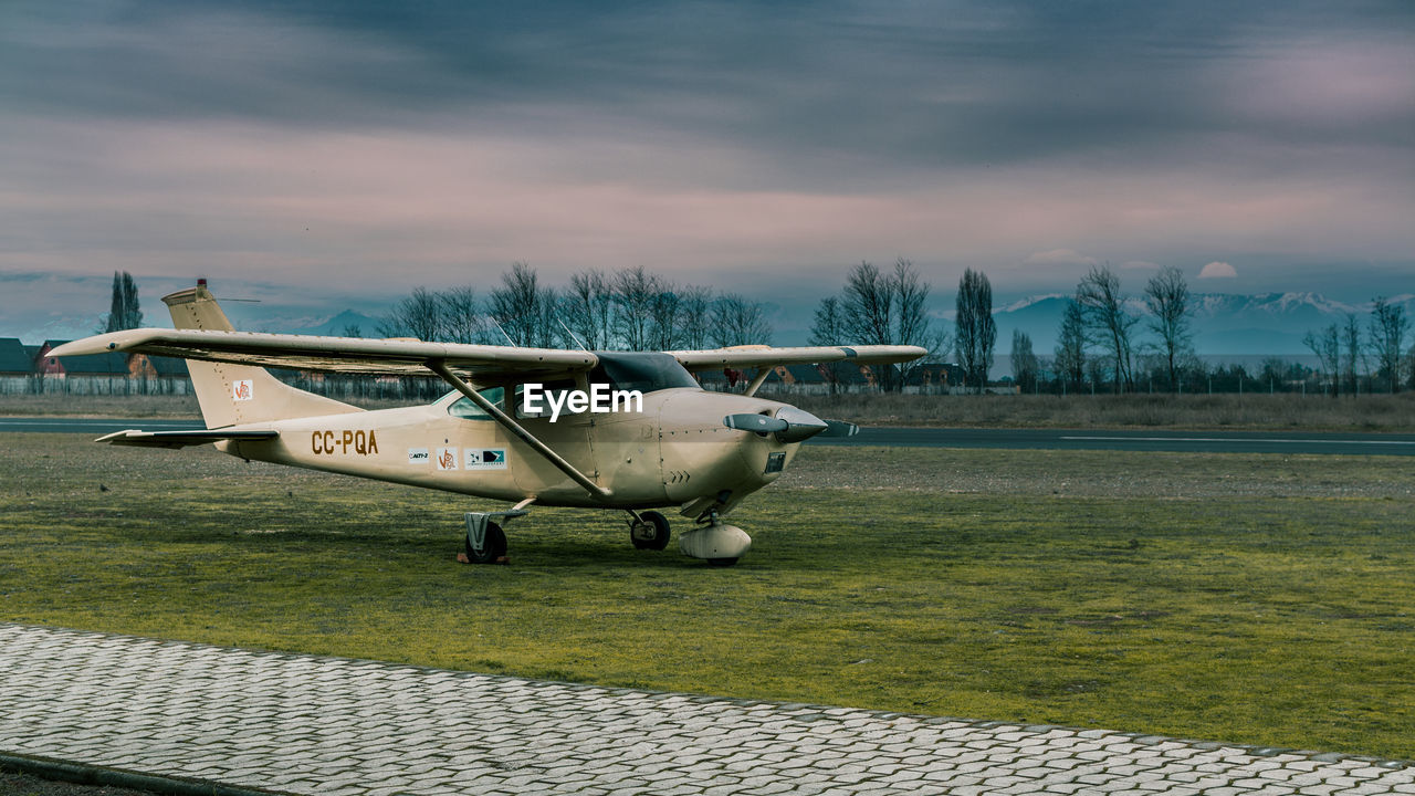 AIRPLANE FLYING OVER AIRPORT