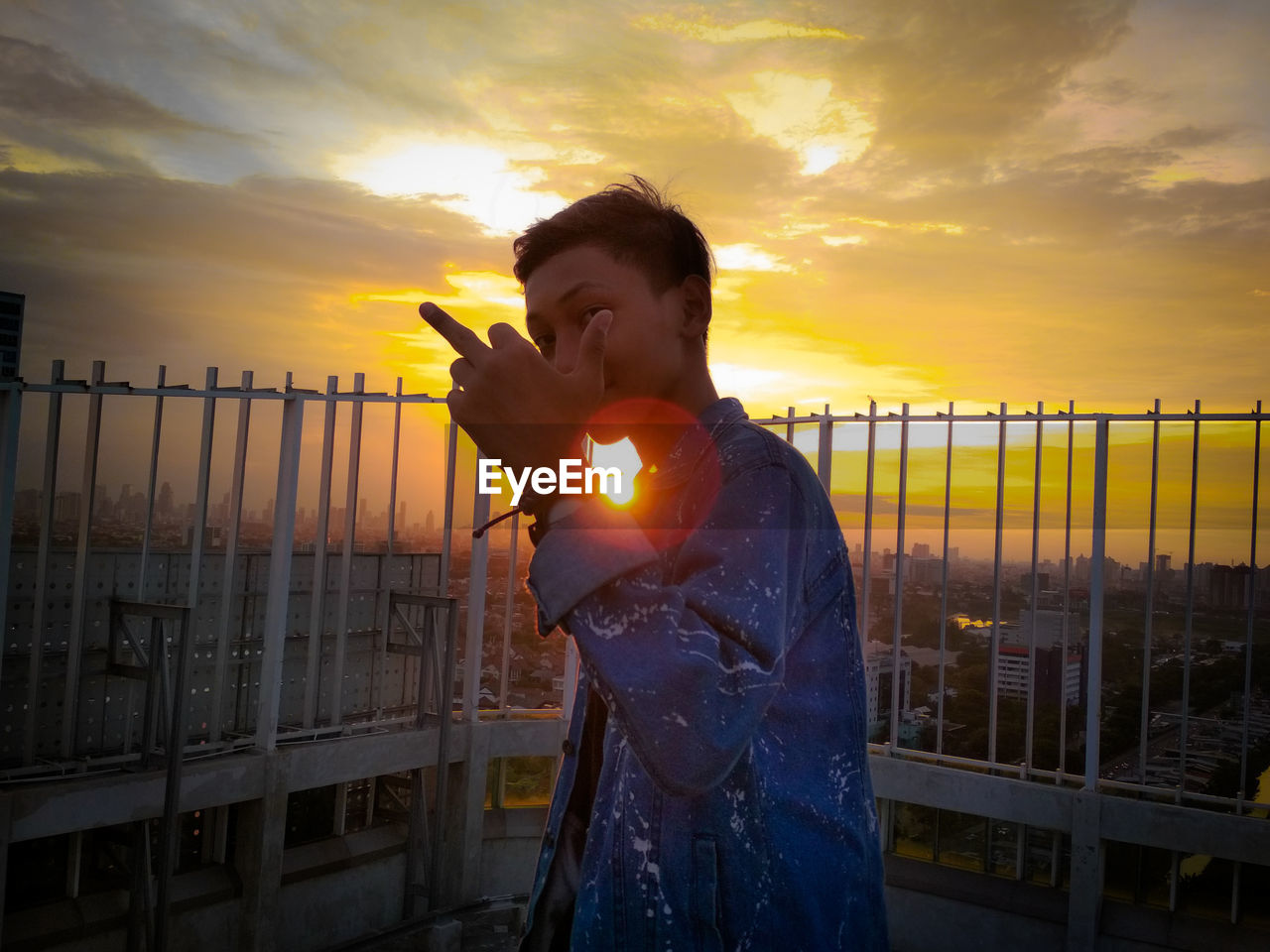 Man standing against sky during sunset