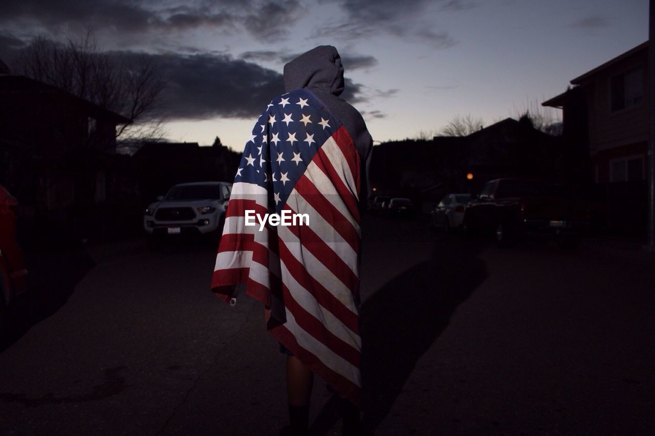 Boy covered in the american flag
