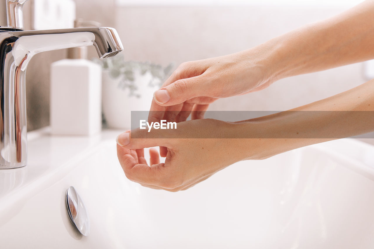 Hands of woman in sink