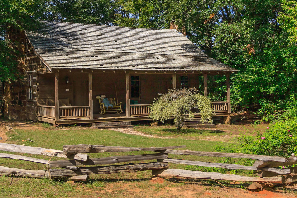 VIEW OF BUILT STRUCTURE WITH TREES IN FOREGROUND