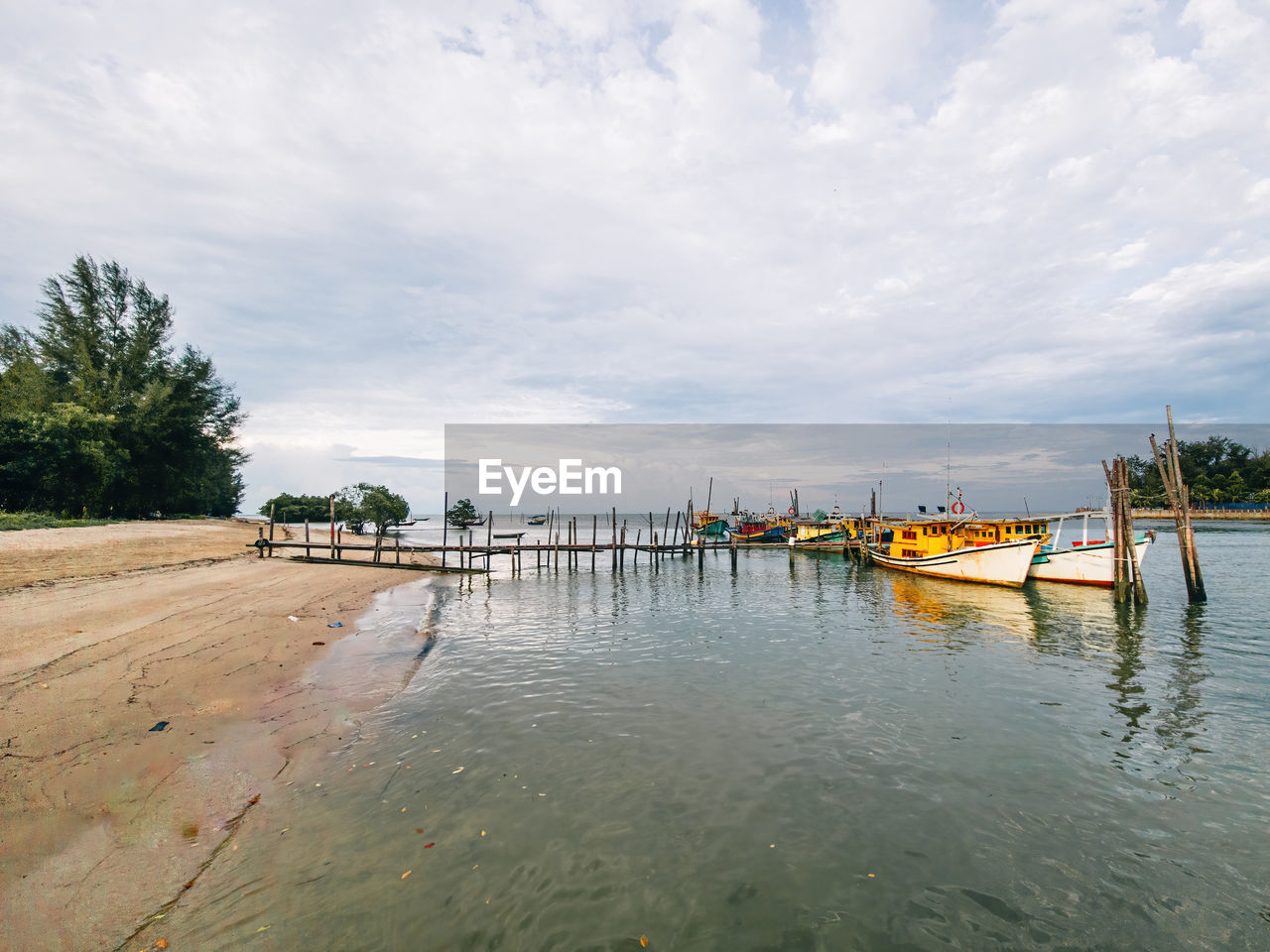 water, nautical vessel, sky, cloud, shore, sea, transportation, nature, boat, boating, travel, tree, land, mode of transportation, vehicle, beach, travel destinations, environment, coast, day, outdoors, bay, body of water, tranquility, scenics - nature, beauty in nature, plant, landscape, trip, vacation, holiday, tropical climate, tourism, no people, architecture, pier, sand, tranquil scene, watercraft