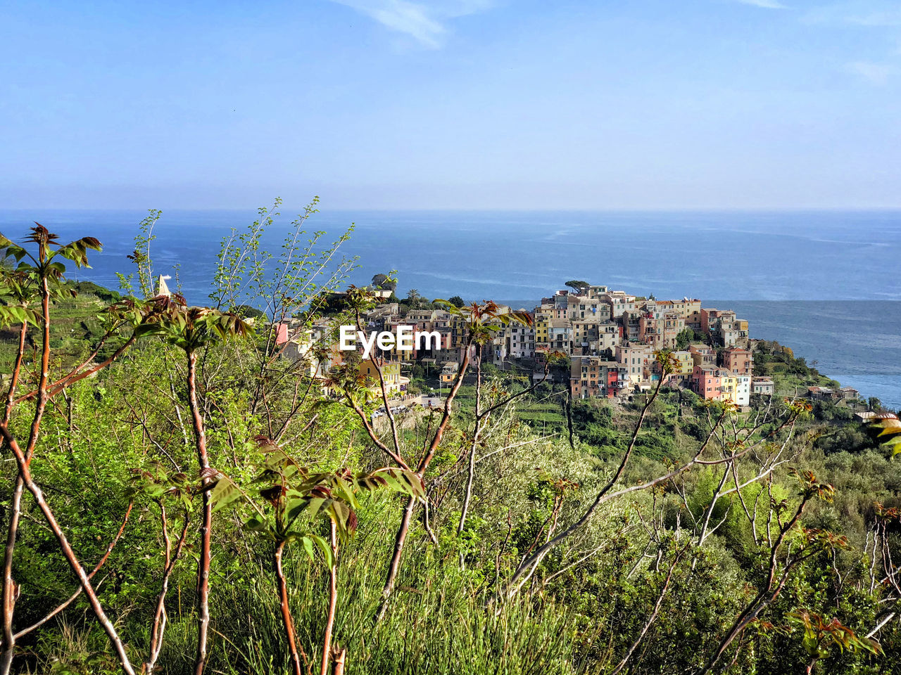 Scenic view of sea by buildings against sky