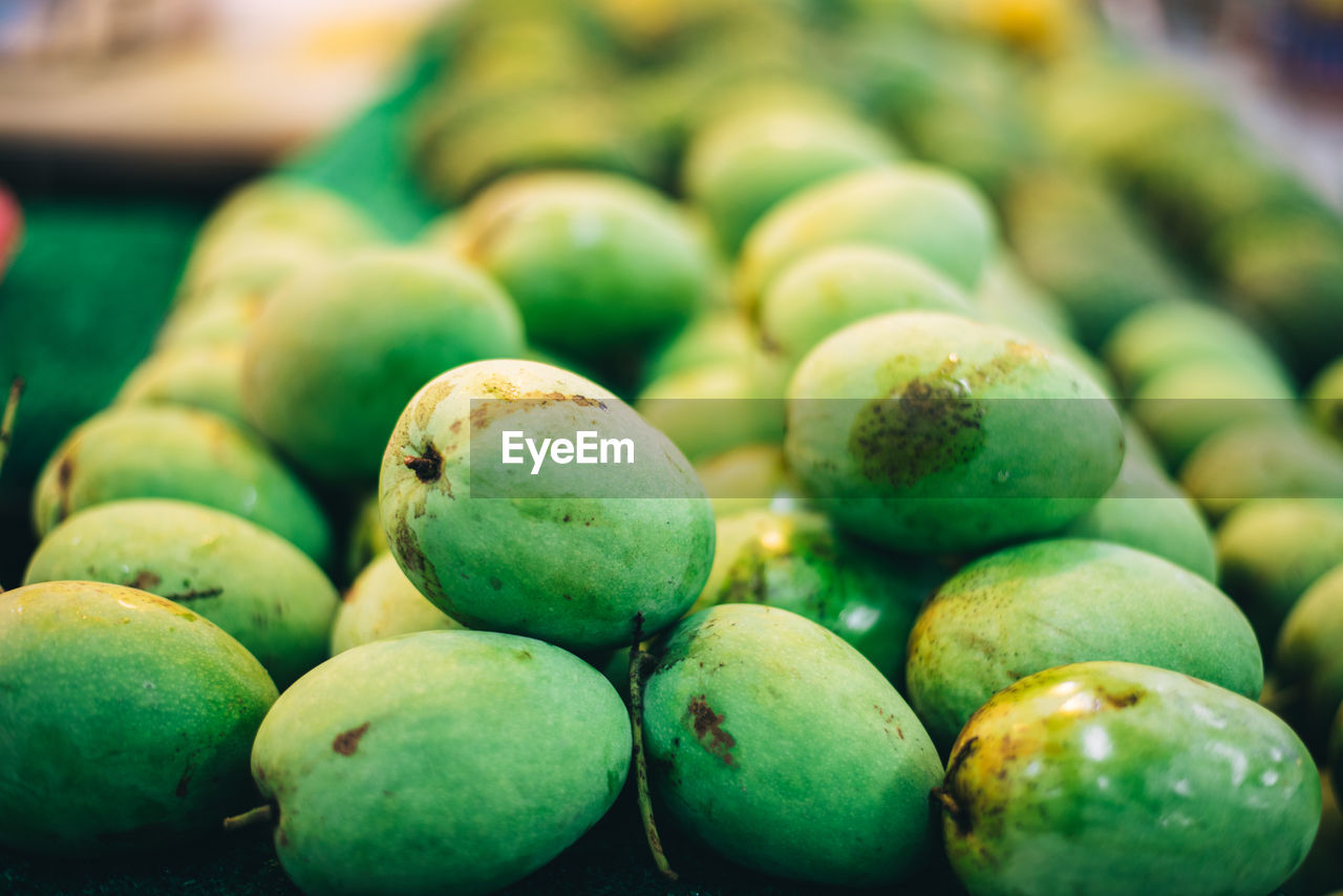 CLOSE-UP OF FRUITS ON GREEN LEAVES