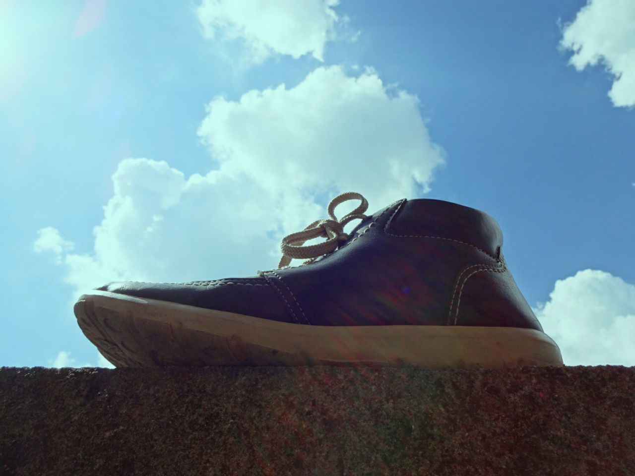LOW ANGLE VIEW OF SHOES ON THE SKY