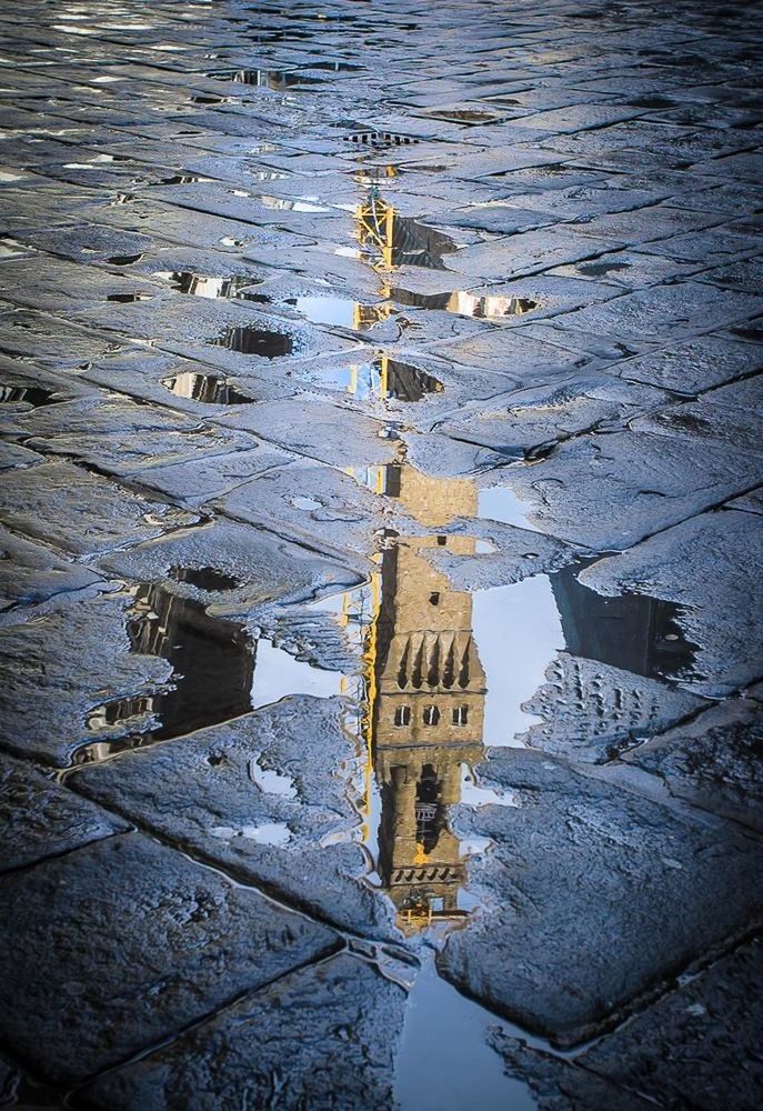 Reflection of building in puddle