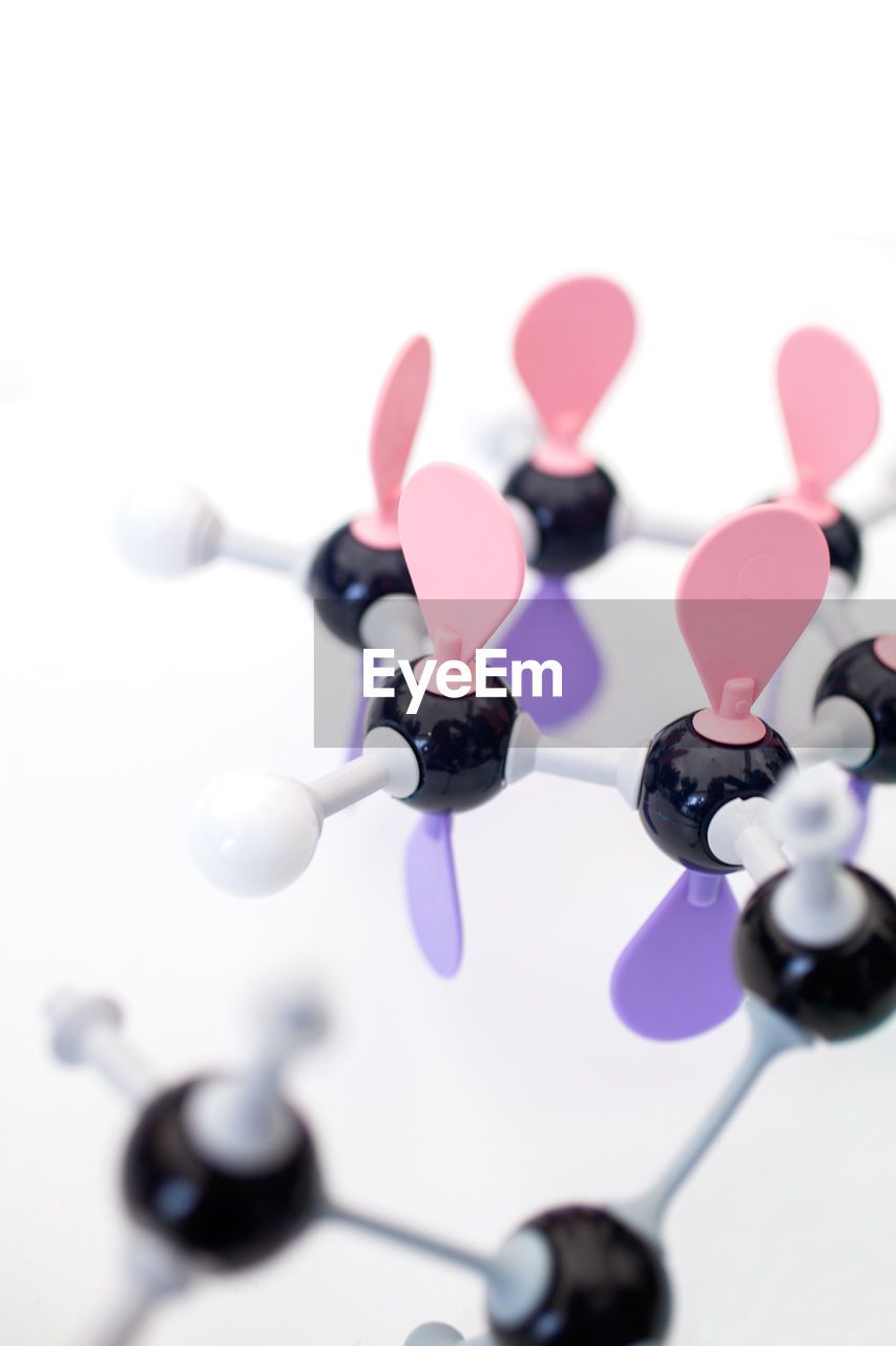 purple, pink, violet, no people, indoors, studio shot, close-up, white background, science, art, petal, fashion accessory, molecular structure