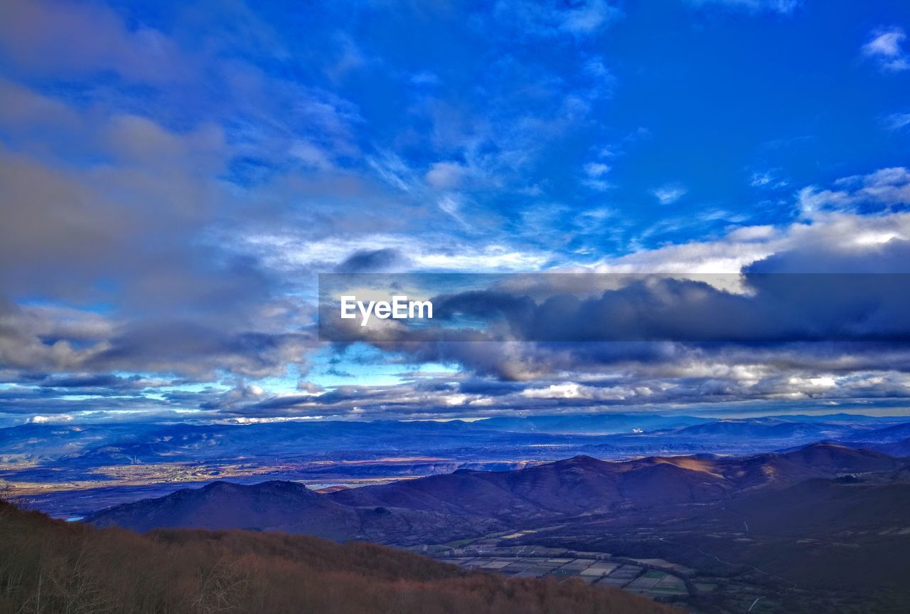 AERIAL VIEW OF CLOUDS OVER LANDSCAPE