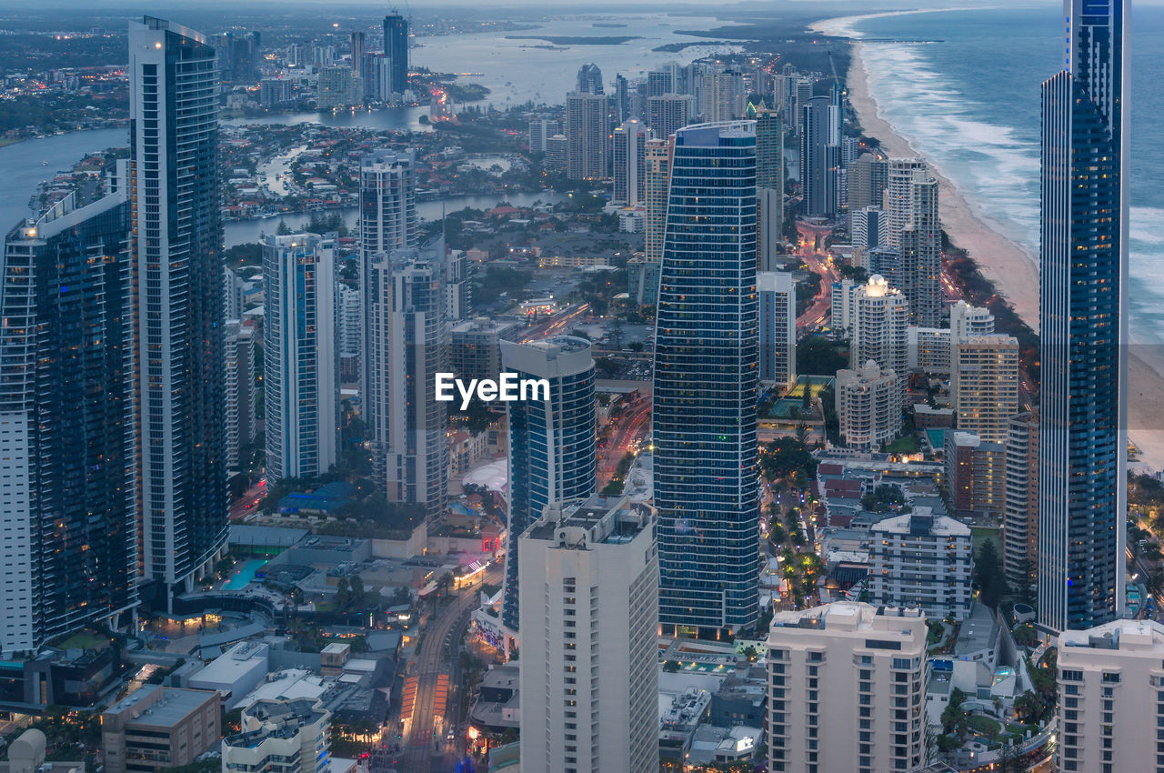 Aerial cityscape with futuristic skyscrapers at dusk. modern city skyline view