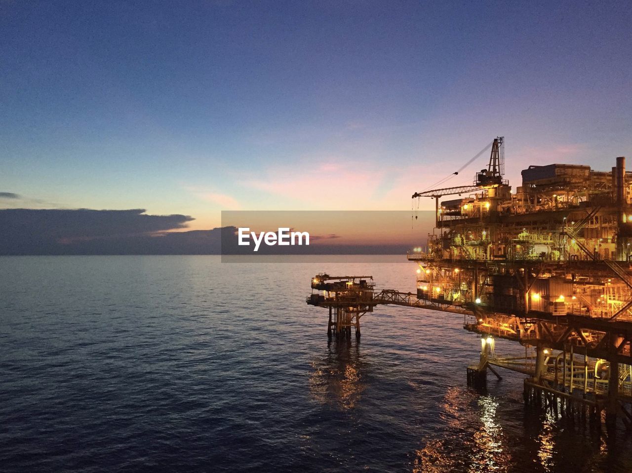 PIER OVER SEA AGAINST SKY AT SUNSET