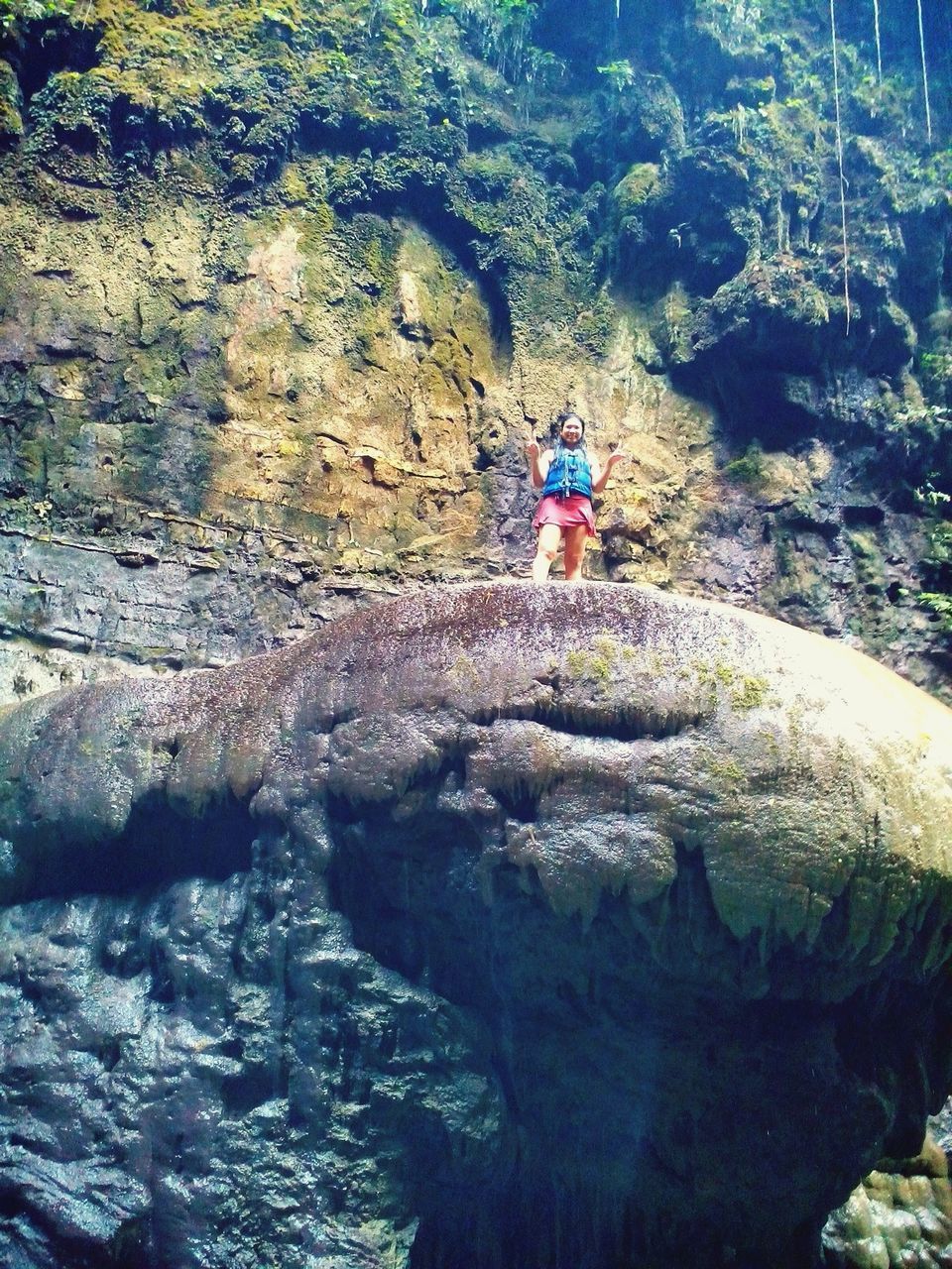 FULL LENGTH OF YOUNG WOMAN ON ROCK