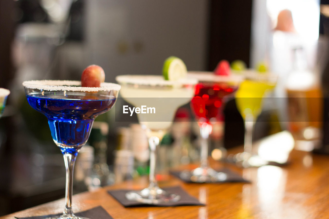 Close-up of colorful cocktails on counter