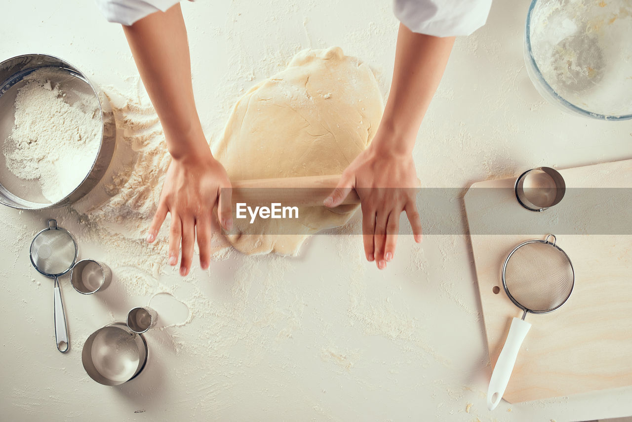 HIGH ANGLE VIEW OF WOMAN PREPARING FOOD