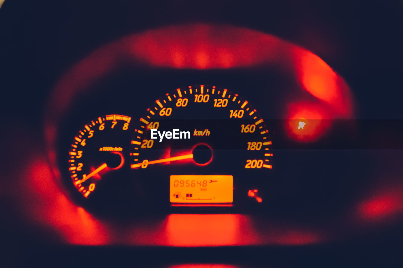 Close-up of illuminated red speedometer in car