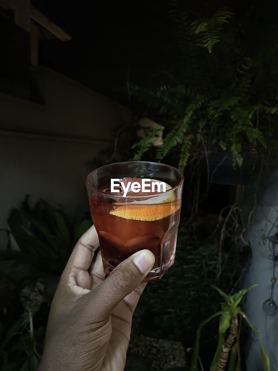 cropped hand of woman holding drink