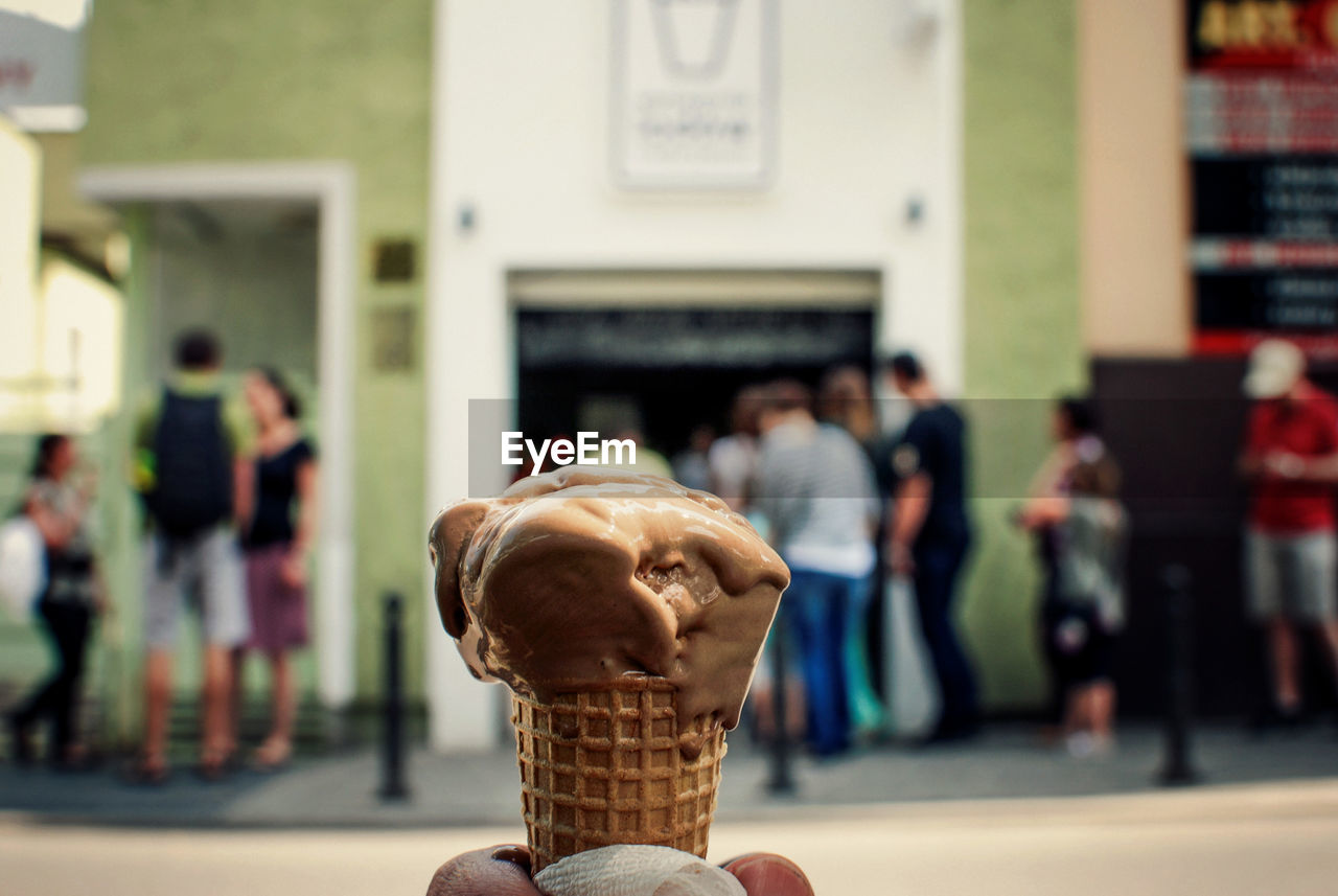 Cropped hand of person holding ice cream cone