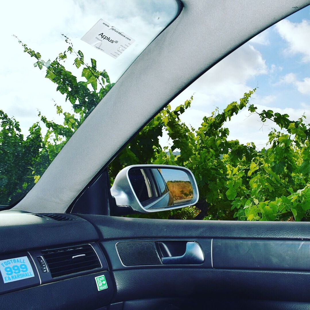 ROAD SEEN THROUGH WINDSHIELD OF CAR