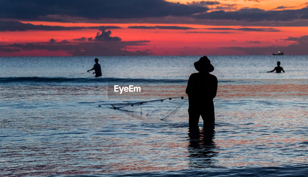 A fisherman is fishing at sunset on koh rong, cambodia