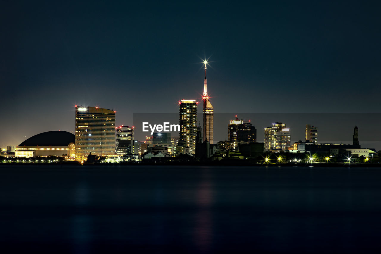 ILLUMINATED BUILDINGS IN CITY AT NIGHT