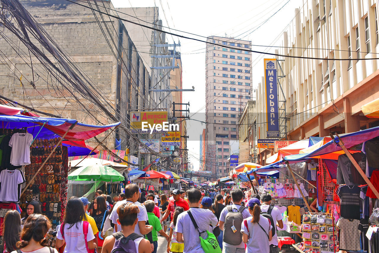 GROUP OF PEOPLE IN MARKET STALL