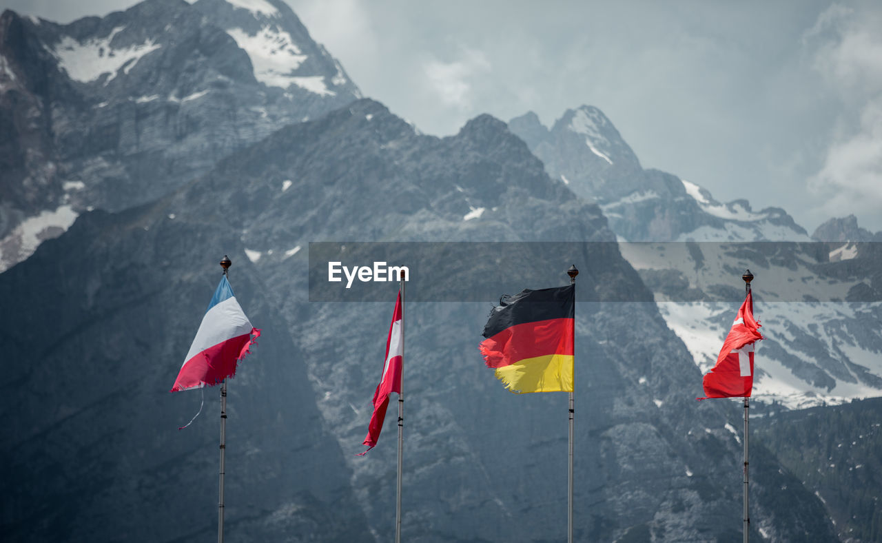 Flags against mountains