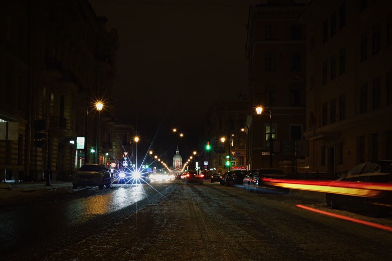 Light trails and cars on street at night