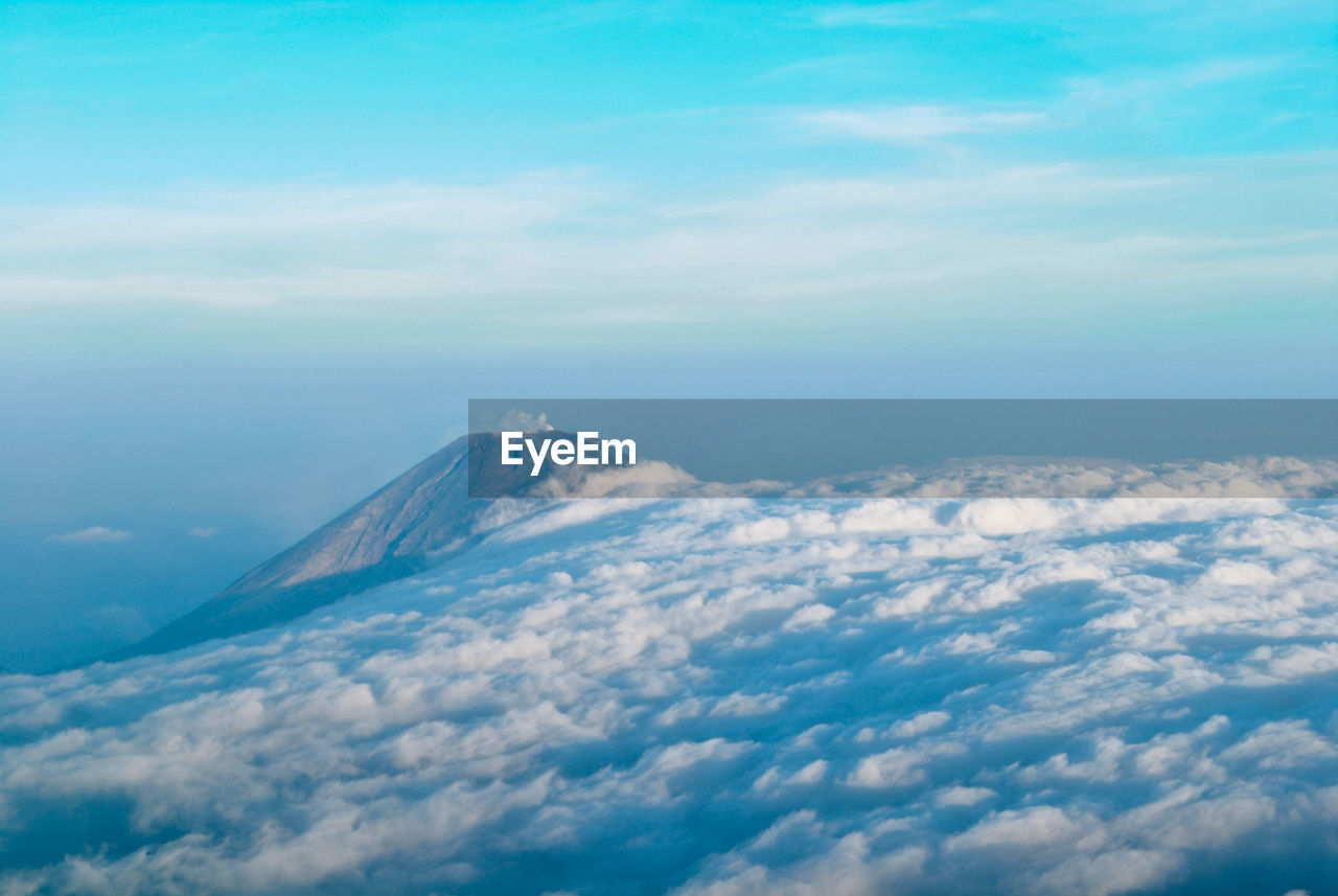 Aerial view of volcanic mountain against sky