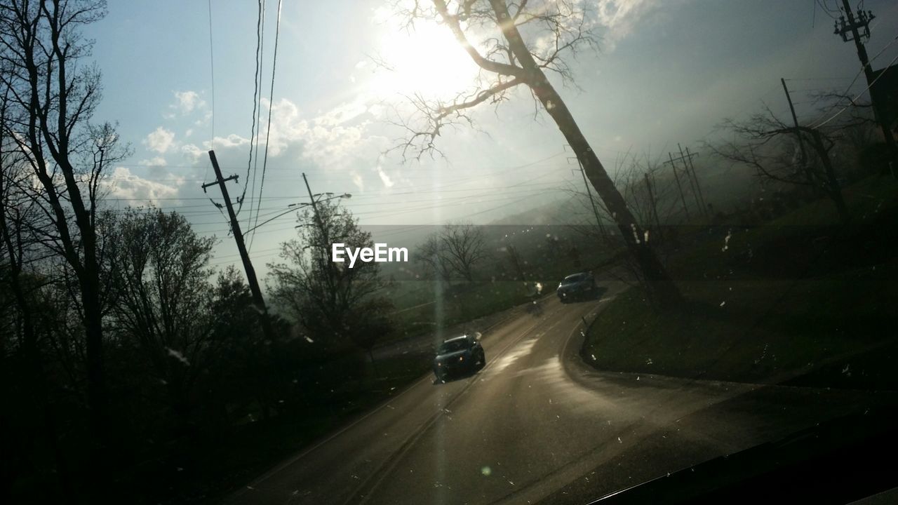 CARS ON ROAD AGAINST SKY