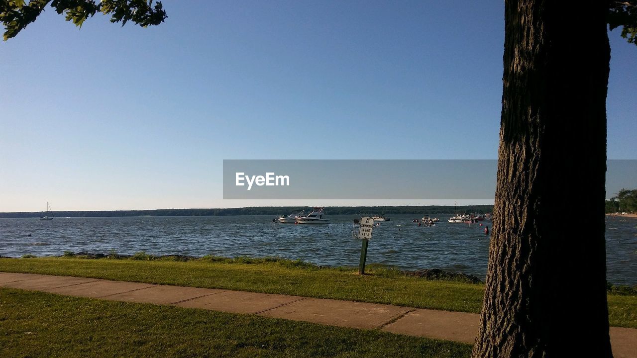 Scenic view of sea against clear blue sky