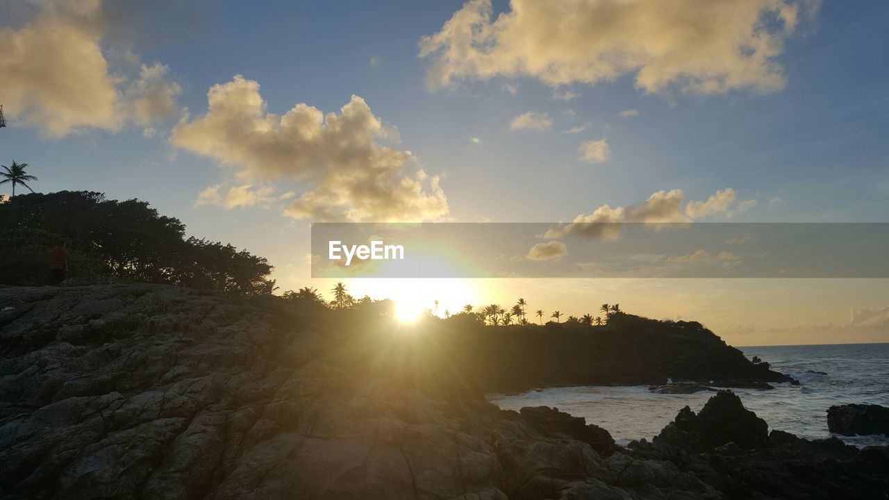 SCENIC VIEW OF SUNSET OVER TREES AGAINST SKY