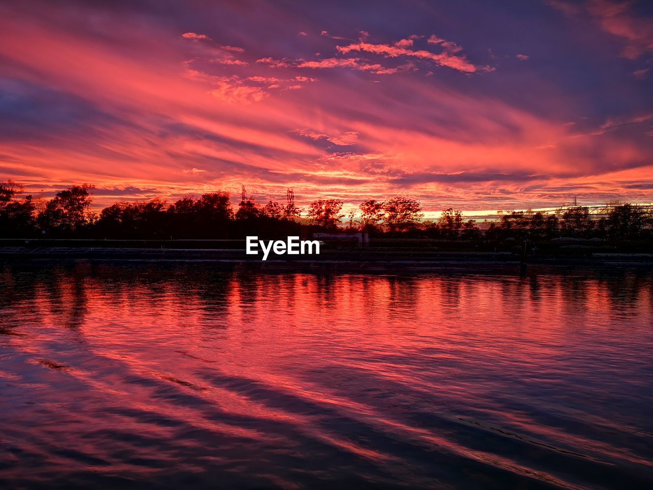 SCENIC VIEW OF LAKE AGAINST ORANGE SKY