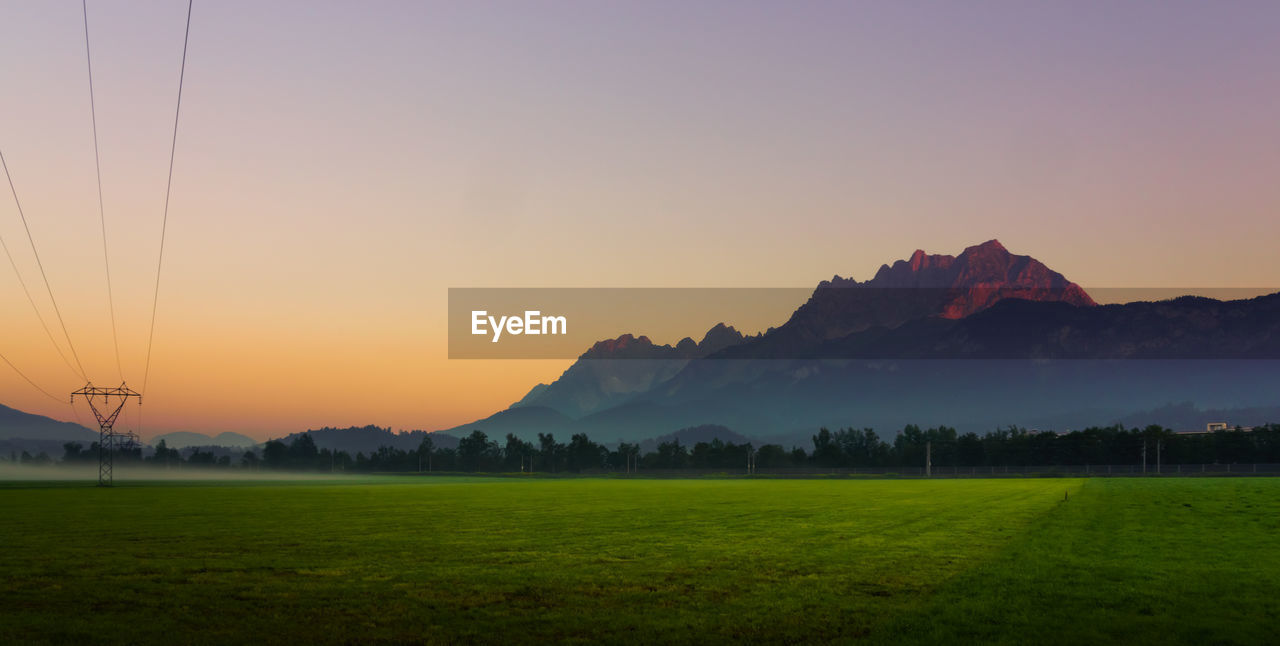 SCENIC VIEW OF FIELD DURING SUNSET