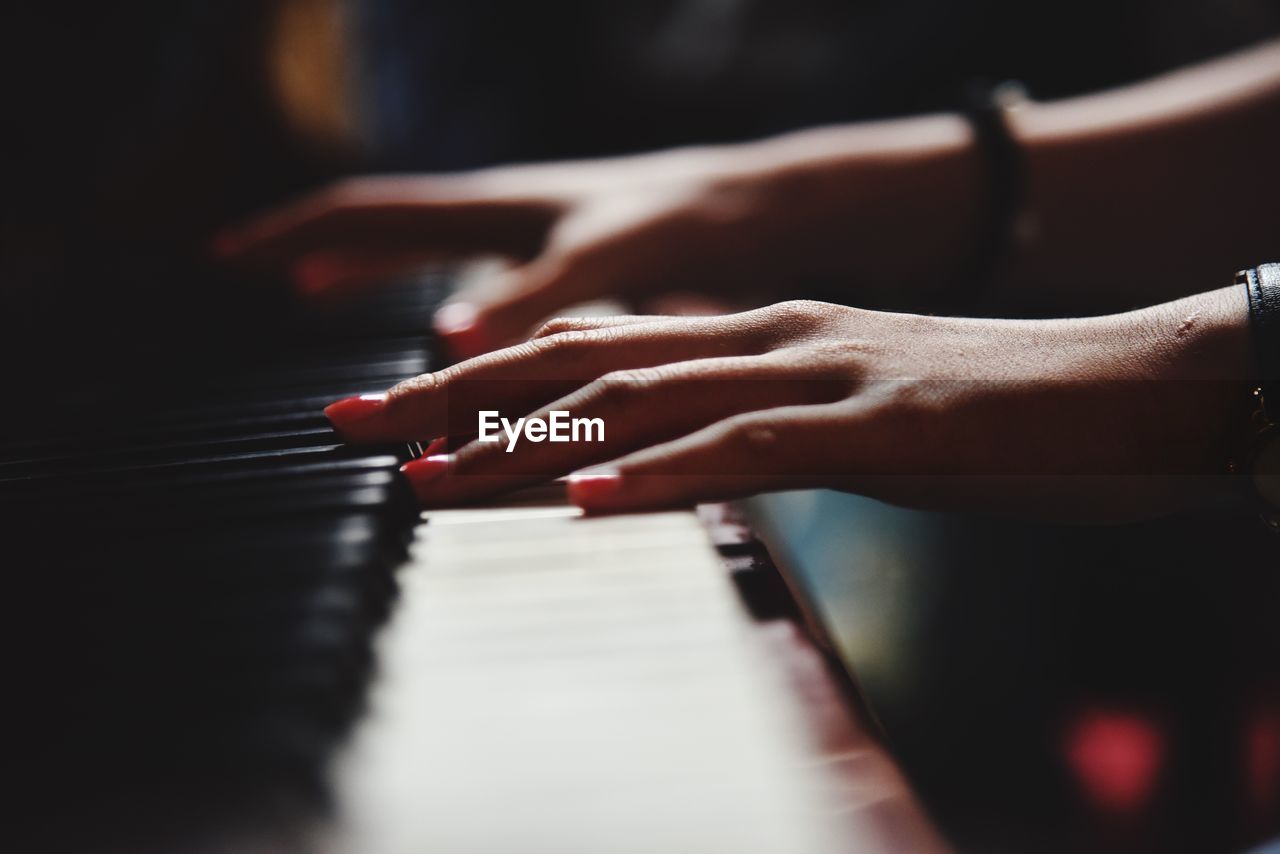 Close-up of hands playing the piano