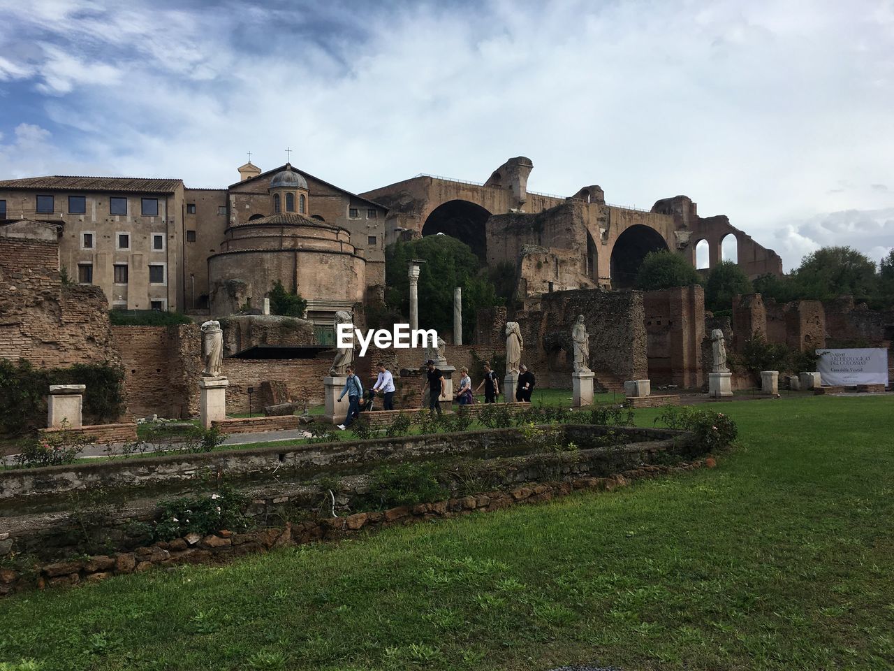 People in old building against sky