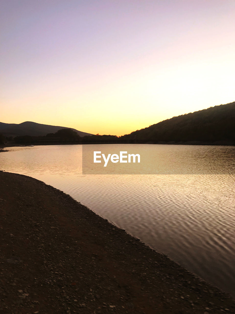 SCENIC VIEW OF SUNSET OVER LAKE