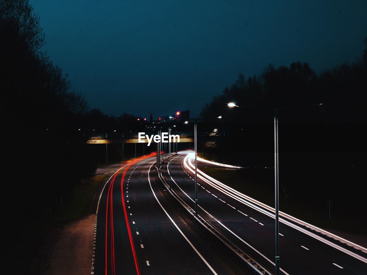 High angle view of light trails on road against sky at night