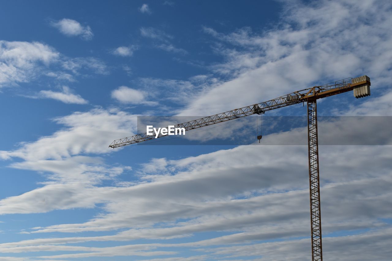 Low angle view of crane against sky