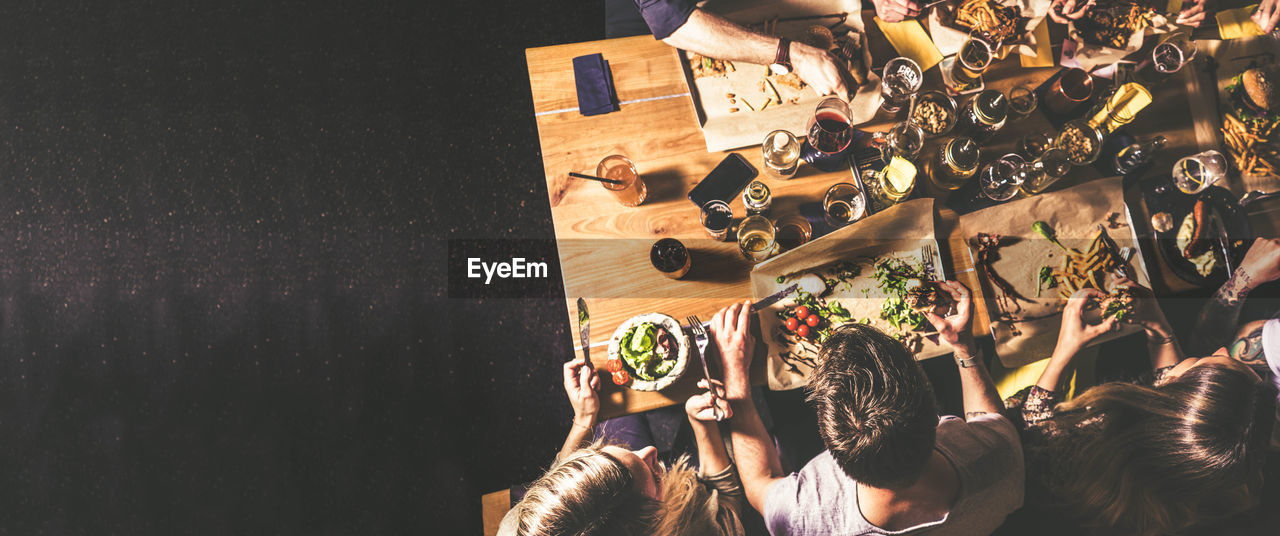 Directly above shot of people sitting by food in restaurant