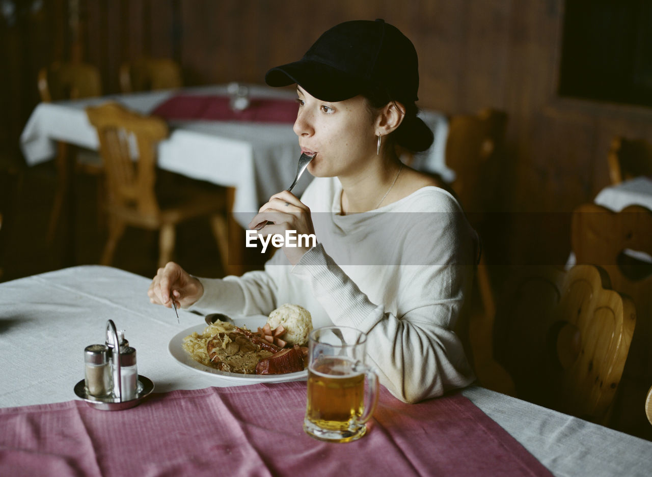 MAN EATING FOOD ON TABLE