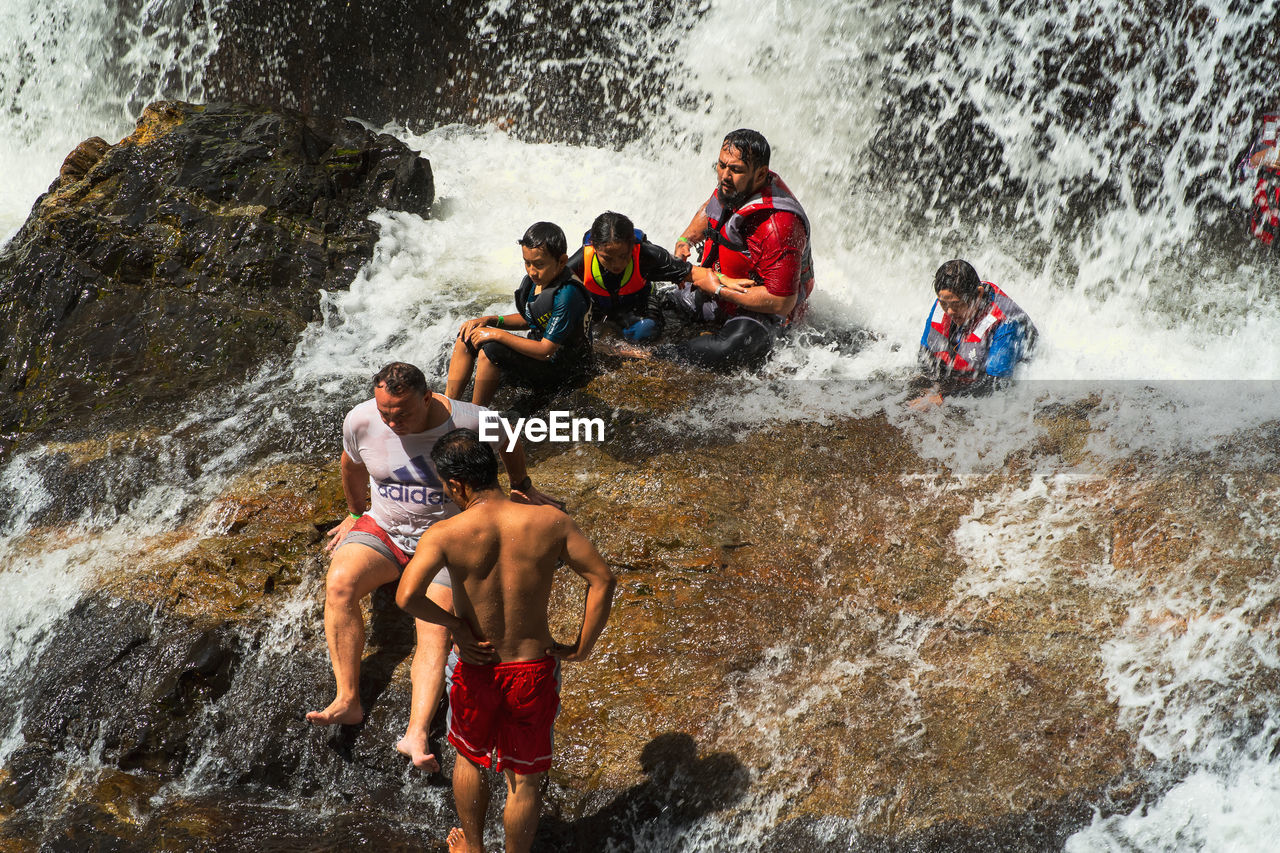 PEOPLE ENJOYING IN WATER AT RIVER