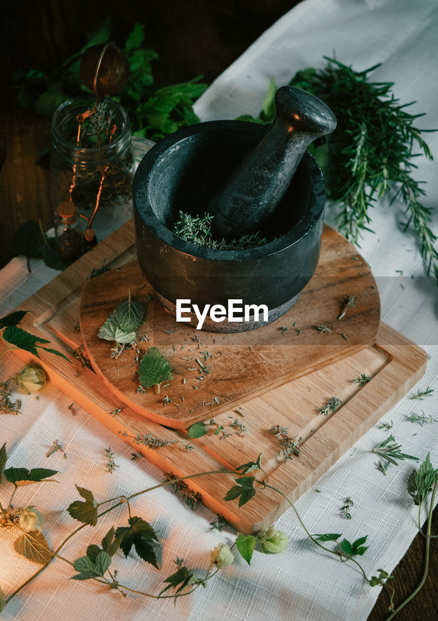 Herbs and spices being ground by mortar and pestle