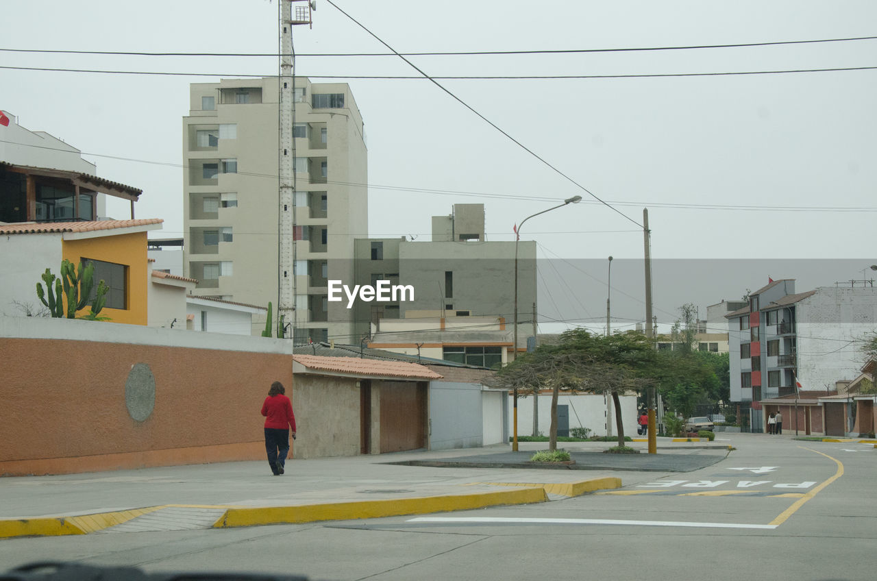 Woman walking at roadside