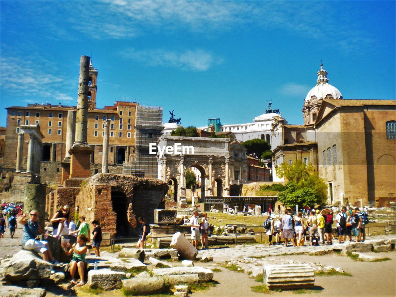 PEOPLE SITTING ON OLD RUIN BUILDING