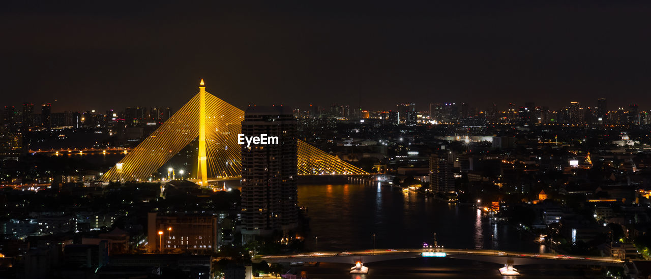 Banner of citiscape of bangkok, thailand at night with view of rama viii bridge